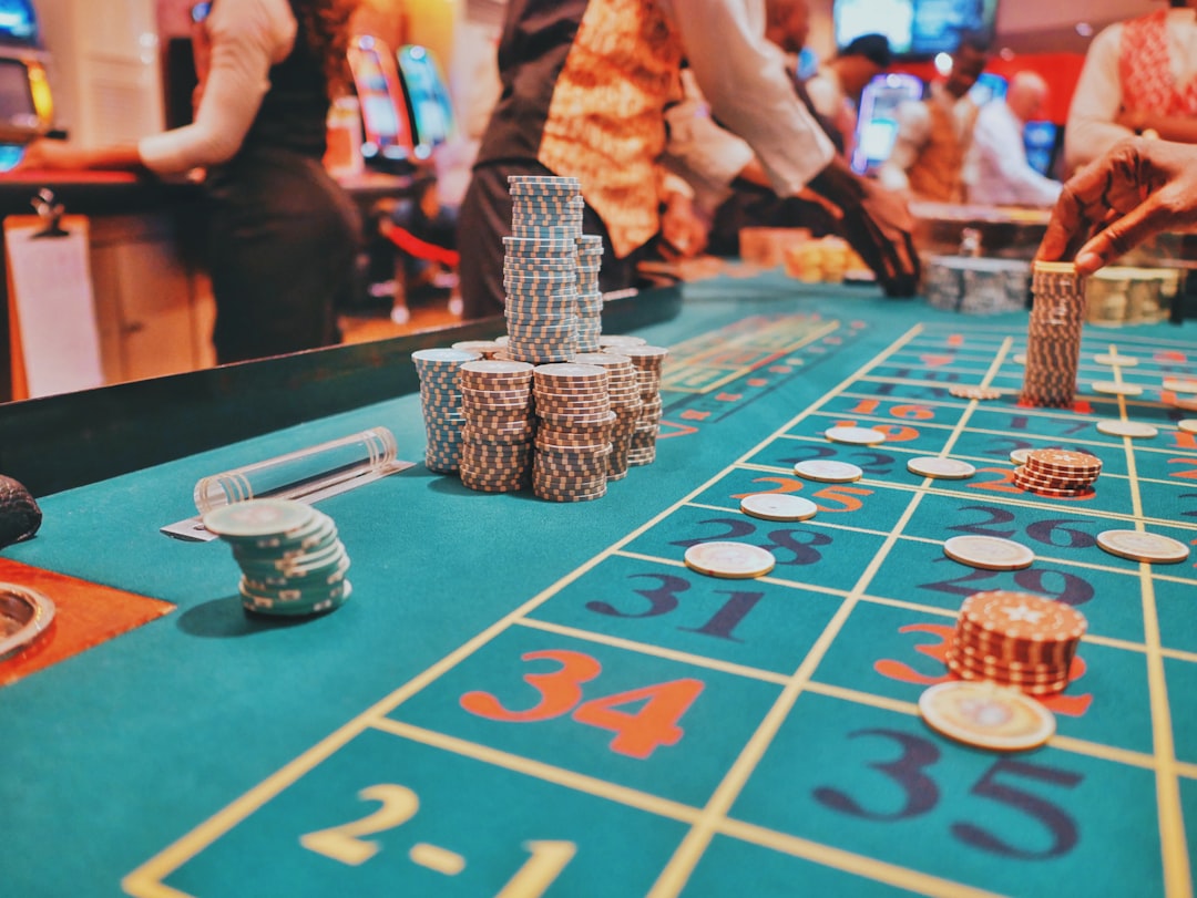 A close-up view of a gaming table with stacked casino chips and roulette layout.
